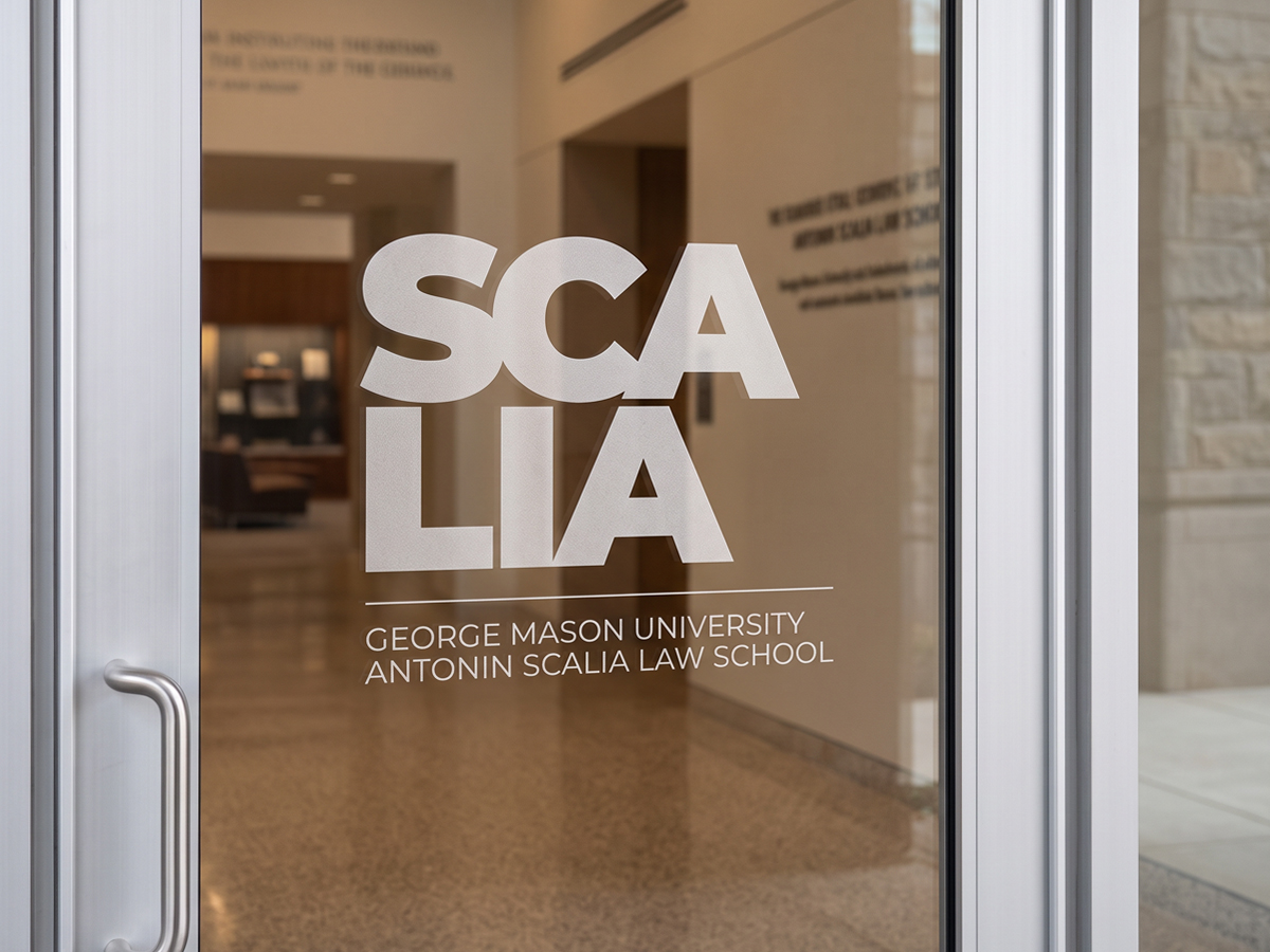 The Scalia logo for the George Mason University Antonin Scalia Law School on a glass door