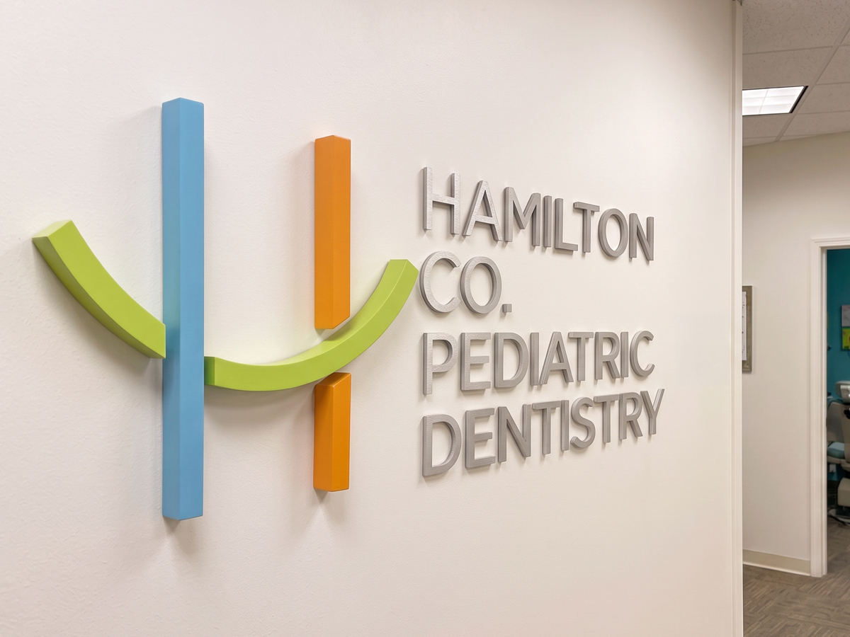 The three-dimensional Hamilton Co. Pediatric Dentistry logo and lettering mounted on a wall