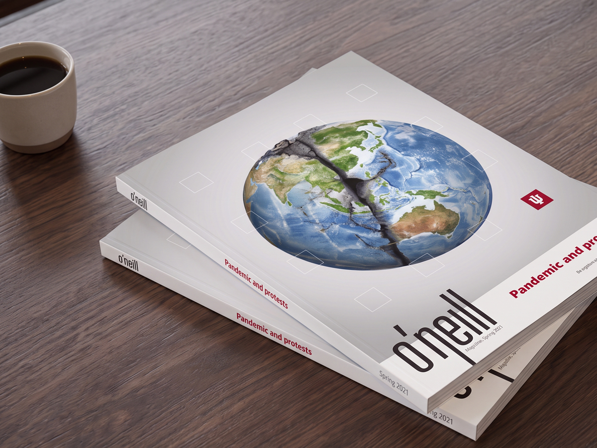 Two stacked copies of o'neill magazine with a cracked globe on the cover beside a cup of coffee